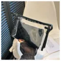 Detailed view of clear PVC travel makeup bag with a black checkerboard inner pouch - Two-Piece Set / Black
