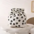Close-up of white quilted drawstring cosmetic pouch featuring a black floral pattern - 12.5*13.5*19cm / Black Small Flower