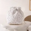 Detailed close-up view of a white quilted cherry print drawstring cosmetic storage bag - 12.5*13.5*19cm / Small Cherry