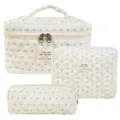 Three-piece set of quilted floral cotton cosmetic bags in cream white with zippers - Bee