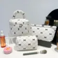 White corduroy cosmetic bag set with black bow print and diamond quilting design - Bow White