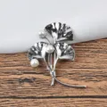 Detailed macro shot of a silver ginkgo leaf brooch featuring three elegant white pearls - Style 02 Triple Leaf / Silver