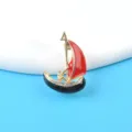 Detailed view of vintage enamel sailboat brooch with sparkling rhinestone accents - Sailboat