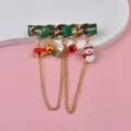 Detailed view of festive Christmas brooch with snowman and bell charms on green ribbon - Green Thick Chain