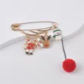Festive Christmas safety pin brooch with enamel charms and a soft red pom-pom detail - Pom Pom