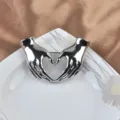 Elegant silver-toned creative brooch featuring two hands forming a heart gesture. - Silver