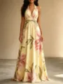 Detailed shot of the floral halter maxi dress showcasing the elegant draped hem and backless design. - S / Warm Yellow