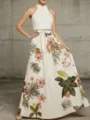 Detailed view of the elegant halter-neck long dress featuring vibrant floral print and waist bow. - S / White