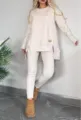 Detail shot of beige split hem long sleeve top and pants set worn in casual indoor setting. - S / Top And Bottom / White