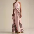 Pink halter floral maxi dress detail showcasing elegant tropical print and waist tie design. - S / Pink