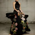 Details of the elegant floral evening dress showing flowy silhouette and tropical print. - S / Black