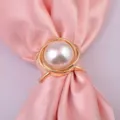 Detail shot of an elegant gold-toned scarf buckle ring featuring a large white central pearl - Style 02