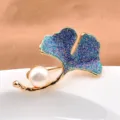 Detail showing the blue glitter texture and natural white pearl of the ginkgo leaf brooch - Ginkgo
