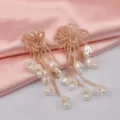 Detaillierte Nahaufnahme von Maiglöckchen-Ohrringen mit Goldperlen und Perlenquasten - Camel