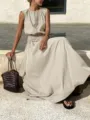 Detail view of a chic beige sleeveless top and long skirt set with elegant pleats for resort wear. - S / Off White