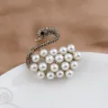 Detailed view of an elegant swan brooch with pearls and sparkling grey rhinestones - White Pearl Swan Style (200810-4)