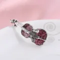 Macro detail of vintage silver violin brooch with pink rhinestones on white plate - Violin Shape (200813-2) / Pink