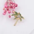 Detailed view of gold palm tree brooch with sparkling green rhinestones - Palm Tree