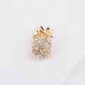 Close-up of a sparkling gold pineapple brooch with clear rhinestone accents - Pineapple