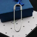 Silver safety pin brooch for sweaters and scarves, presented with a blue gift box. - White K