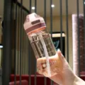 Portable plastic water bottle with straw and capacity scale, ideal for daily sports and school use. - 500ml / Pink