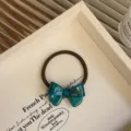 Elegante donkergroene haarelastiek met acetaat strik goudkleurig detail en bruin band - Blauw