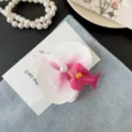 Sweet orchid flower hair clip with pink gradient petals and elegant pearl detail for women - White Side Clip