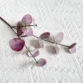 Close-up view of artificial eucalyptus leaf branch featuring realistic purple texture detail. - Olive Green