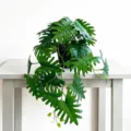 Close-up detail of artificial potted green plant with split leaves on table, natural decor style. - Dark Green Split Leaf Style (YC185)