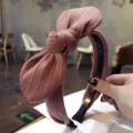 Elegant pink ribbed fabric headband featuring a large rabbit ear bow and non-slip teeth - Pink