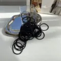 High-quality black braided elastic hair ties displayed on a silver decorative tray - All Black