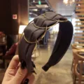 Stylish black fabric wide headband featuring chic interlocking gold circular ring accents - Gray