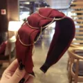 Elegant wine red pleated fabric wide headband with stylish interlocking gold metal ring accents - Burgundy