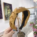Elegant mustard yellow wide braided headband featuring pearl and rhinestone floral details. - Yellow