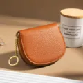 Brown leather half-round coin purse with zipper closure and key chain, stylish card holder. - Tan