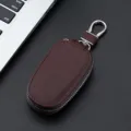 Brown leather car key case with metal hook and secure zipper closure for daily convenience. - 9116 Coffee