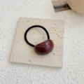 Elegant burgundy acrylic jelly hair tie with black elastic band on stone base - Burgundy