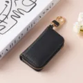 Custodia per chiavi in pelle sintetica nera con cerniera e dettagli dorati, elegante accessorio. - 9125 nero