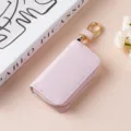 Portachiavi in pelle rosa con cerniera e dettagli dorati, organizer elegante e compatto. - 9125 Rosa