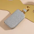 Custodia per chiavi auto in pelle argentata glitterata con ferramenta dorata di lusso e chiusura. - Argento