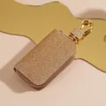 Astuccio per chiavi auto in pelle glitterata con zip metallica per la custodia quotidiana. - Oro