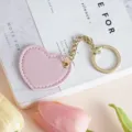 Cute pink heart leather keychain for bags and car keys. Stylish metal ring pendant accessory. - Pink