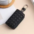 Astuccio portachiavi per auto in pelle intrecciata nera con cerniera e gancio in metallo. - Nero
