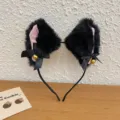 Plush black cat ear headband with pink inner ears, black bows, and small golden bells. - Black Cat Ears with Bells / Black