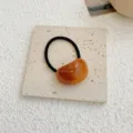 Elegant amber colored acrylic jelly hair tie with durable black elastic band for women - Tortoise