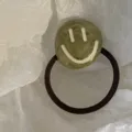 Green marbled acrylic hair tie with a white smiley face on white paper background - Green Smiling