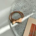 Korean style minimalist acrylic bow hair tie with a smooth jelly texture in nude beige - Khaki