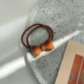 Minimalist Korean style orange acrylic bow hair tie with translucent jelly texture - Scrunchie Coffee