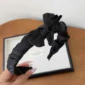 Elegant black pleated fabric headband with large bow detail for chic vintage style - Black