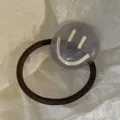 Korean style acrylic hair tie featuring a grey jelly marble charm with white smiley face - Smiley Face Acrylic Style / Gray